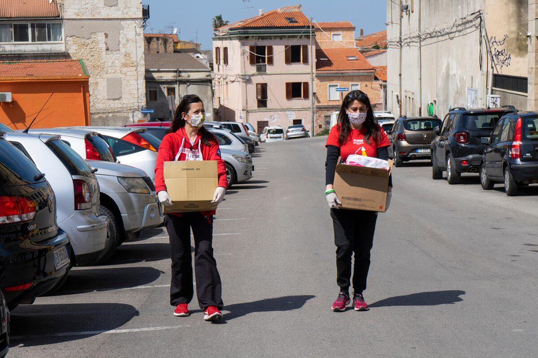 Image of volunteers caring care kits in the street