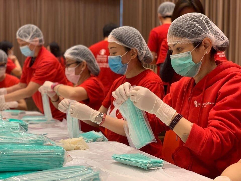 Image of volunteers packing care kits for Save The Children